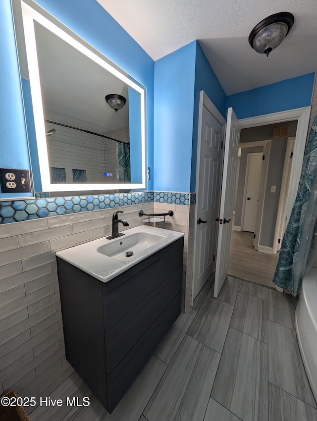 13596 Hobbton Hwy, Newton Grove, NC 28366 - full bathroom featuring tile walls, vanity, a shower with shower curtain, and wainscoting