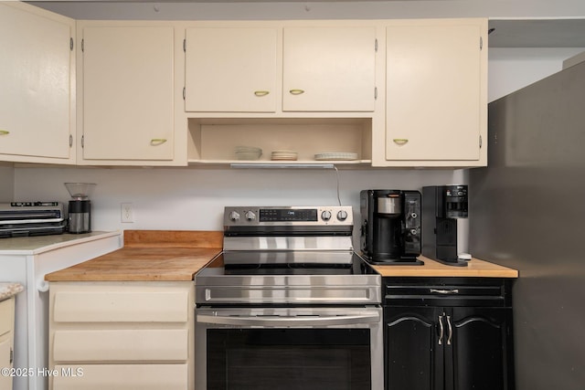 kitchen featuring white cabinetry, open shelves, dark cabinets, and appliances with stainless steel finishes