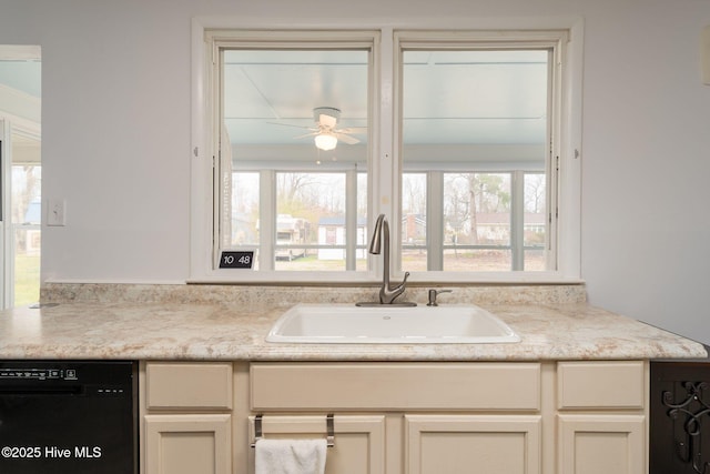 kitchen featuring light countertops, black dishwasher, a ceiling fan, and a sink