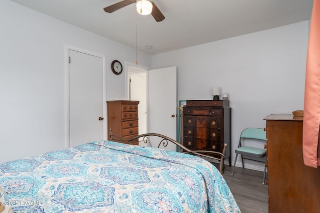 bedroom featuring wood finished floors, baseboards, and ceiling fan