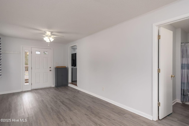 entrance foyer featuring wood finished floors, baseboards, and ceiling fan