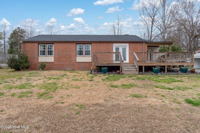 rear view of house with a deck and brick siding