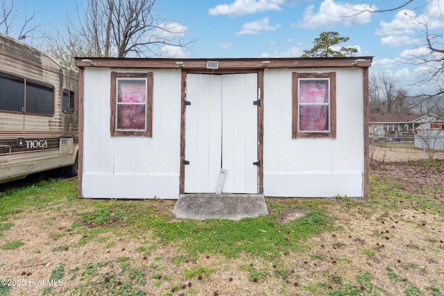 view of outbuilding with an outdoor structure and fence