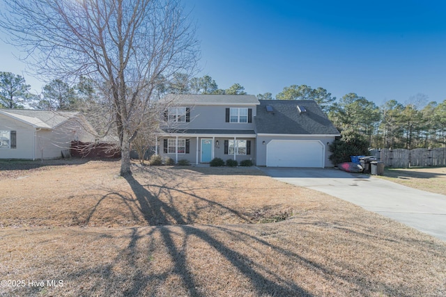 view of front facade with concrete driveway, an attached garage, and fence