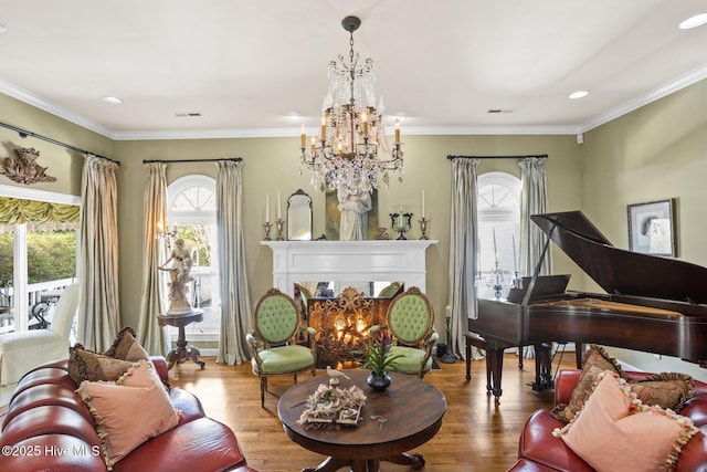 living area featuring visible vents, crown molding, a lit fireplace, and wood finished floors