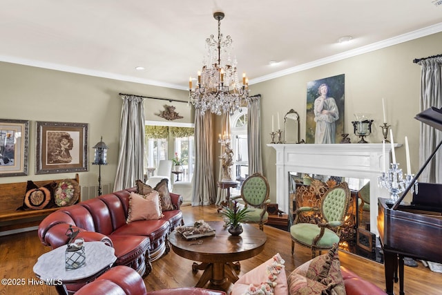 living room featuring a notable chandelier, wood finished floors, a high end fireplace, and ornamental molding