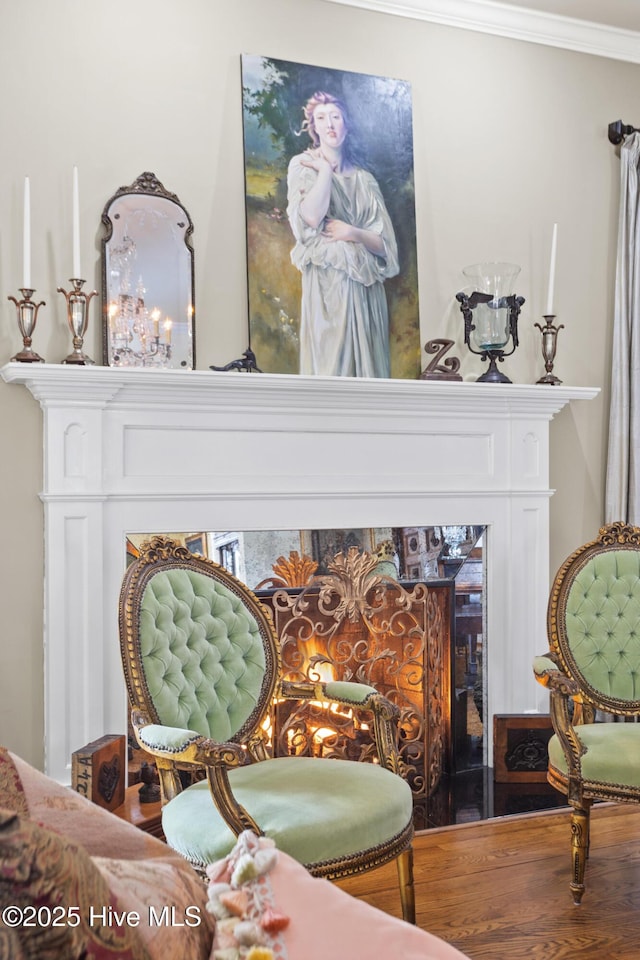 interior details featuring a fireplace, wood finished floors, and ornamental molding