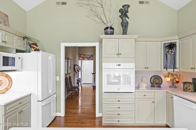 kitchen featuring visible vents, white appliances, light countertops, and dark wood-type flooring