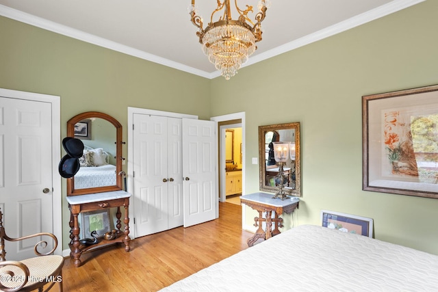 bedroom featuring a chandelier, wood finished floors, and ornamental molding