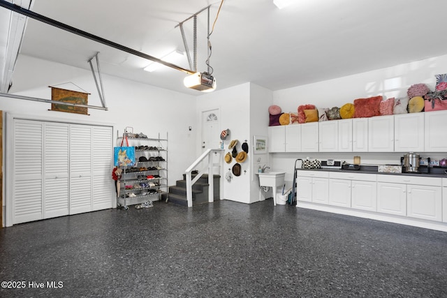 garage featuring a sink and a garage door opener