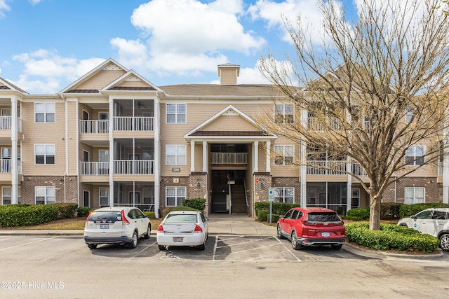 view of building exterior with uncovered parking