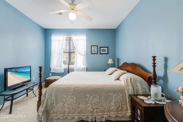 carpeted bedroom with visible vents and a ceiling fan