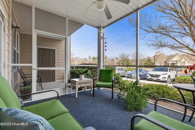 sunroom / solarium with a ceiling fan