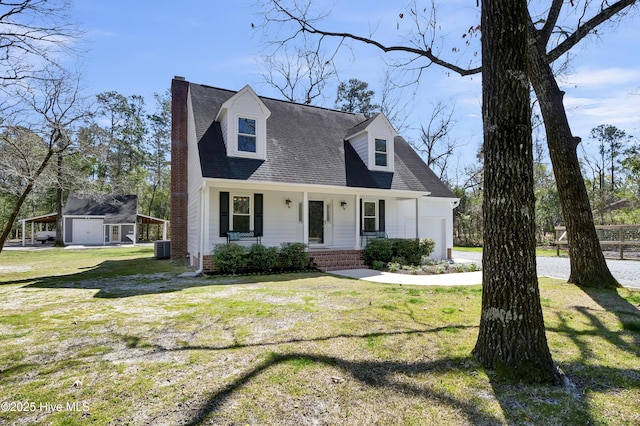 new england style home with central air condition unit, driveway, a front yard, a garage, and a chimney