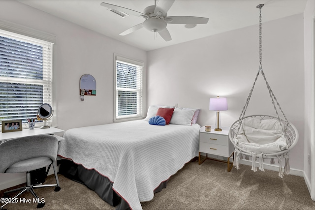 carpeted bedroom with a ceiling fan and visible vents