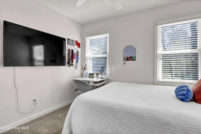 carpeted bedroom with baseboards and a ceiling fan