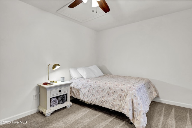 bedroom featuring ceiling fan, attic access, baseboards, and carpet floors