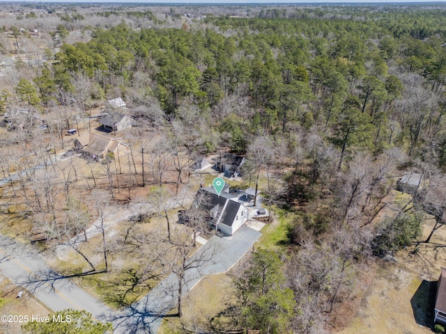 birds eye view of property featuring a view of trees