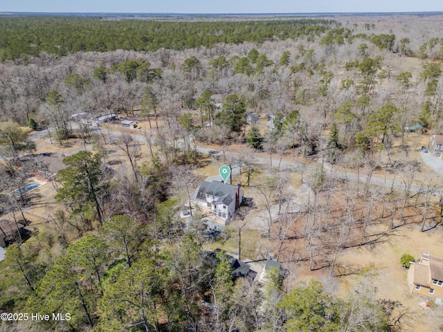 birds eye view of property with a forest view