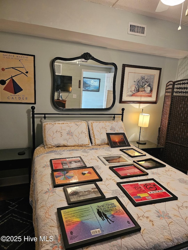 bedroom with visible vents and a ceiling fan