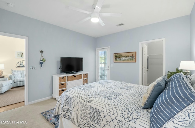 bedroom featuring light carpet, baseboards, visible vents, ceiling fan, and a spacious closet