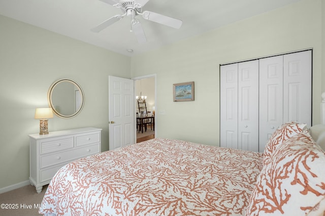 bedroom featuring a ceiling fan, a closet, light colored carpet, and baseboards