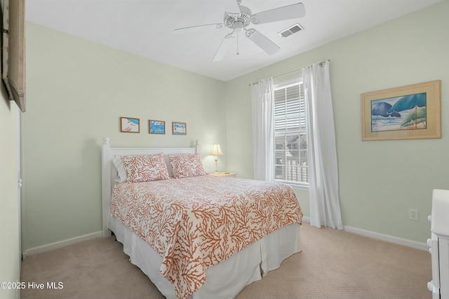 bedroom with a ceiling fan, light carpet, visible vents, and baseboards