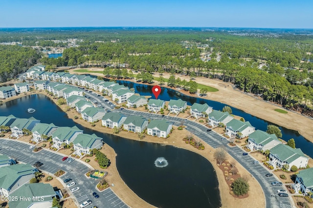 aerial view with a residential view, a water view, and a view of trees