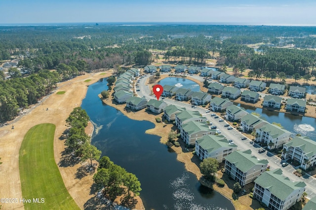 aerial view with a residential view, a water view, and a forest view