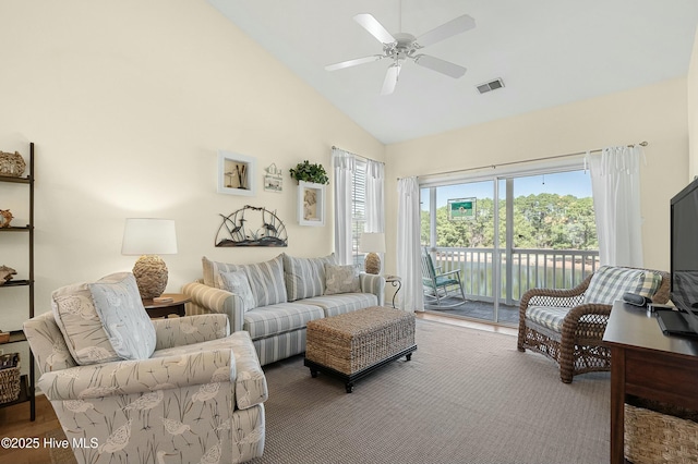 living area with a ceiling fan, visible vents, plenty of natural light, and high vaulted ceiling