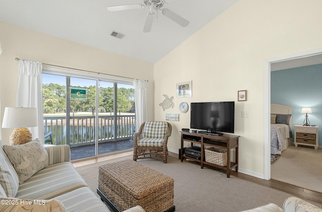 living room with high vaulted ceiling, a ceiling fan, visible vents, and baseboards