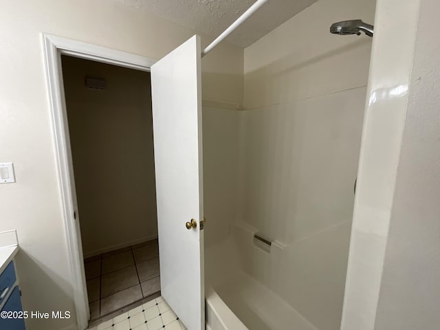 full bath with a shower and a textured ceiling