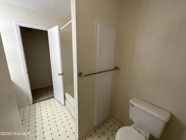 full bathroom with toilet, bathtub / shower combination, and a textured ceiling