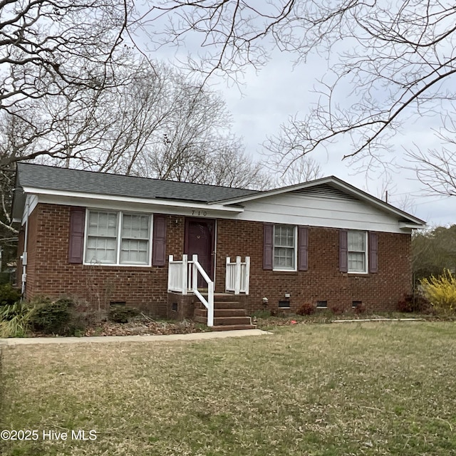 view of front facade featuring crawl space, brick siding, a front lawn, and a shingled roof