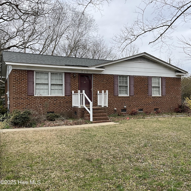 view of front of home with crawl space, a front yard, brick siding, and roof with shingles