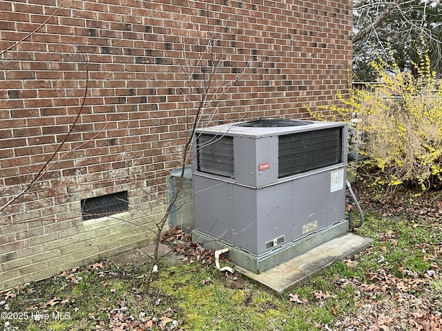 exterior details with cooling unit and brick siding