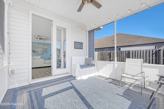 sunroom / solarium featuring ceiling fan