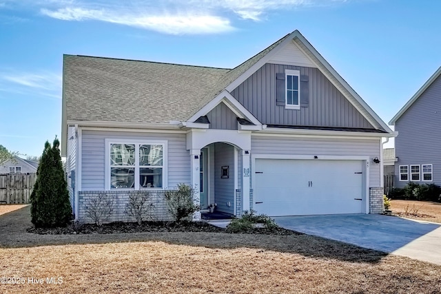 view of front of property featuring brick siding, fence, board and batten siding, and driveway