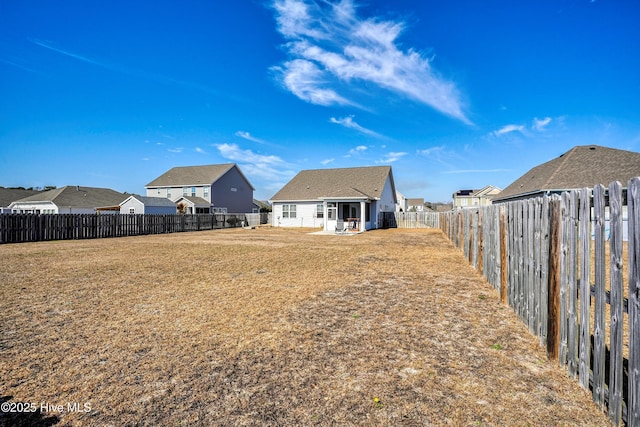 back of house with a lawn, a patio, and a fenced backyard