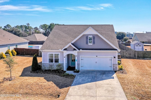 view of front of home with board and batten siding, a shingled roof, fence, concrete driveway, and a front yard