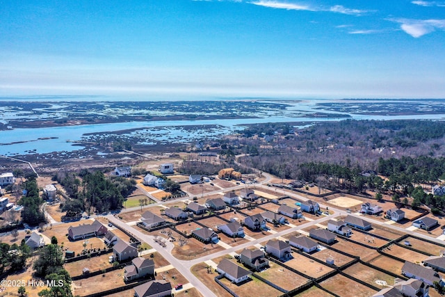 drone / aerial view featuring a residential view and a water view