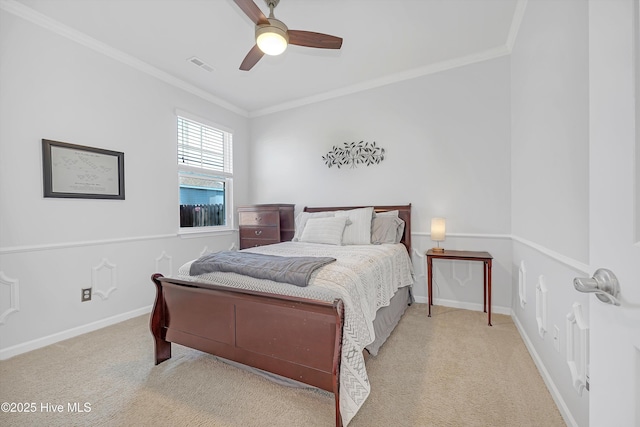 carpeted bedroom with visible vents, ceiling fan, baseboards, and ornamental molding