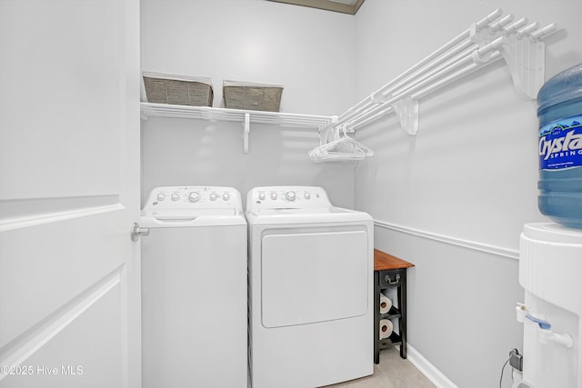 laundry area with washer and clothes dryer, laundry area, and tile patterned floors