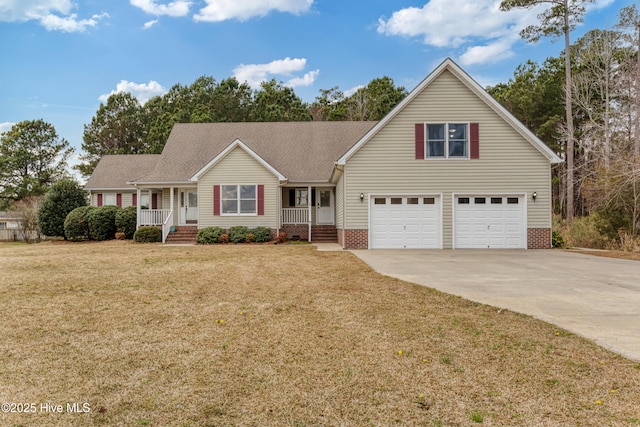 traditional home with a front yard, a porch, a garage, and driveway