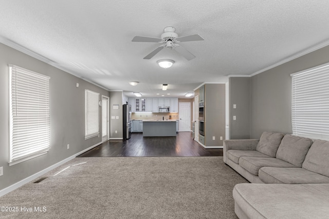 living room with visible vents, a textured ceiling, ornamental molding, and a ceiling fan