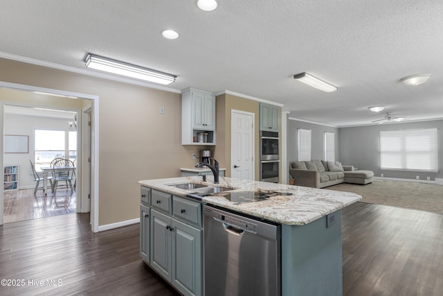 kitchen with an island with sink, a sink, ornamental molding, and appliances with stainless steel finishes