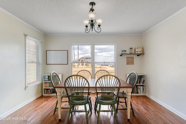 dining room featuring baseboards, an inviting chandelier, and wood finished floors