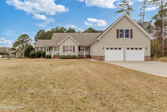 traditional home with a porch, driveway, a garage, and a front lawn