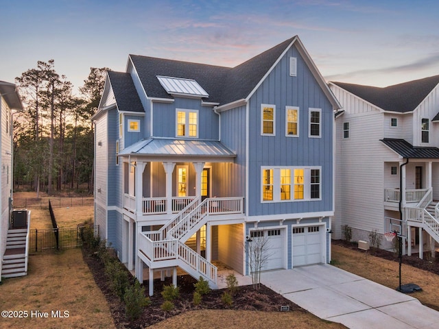 view of front of property featuring covered porch, board and batten siding, stairs, and a standing seam roof