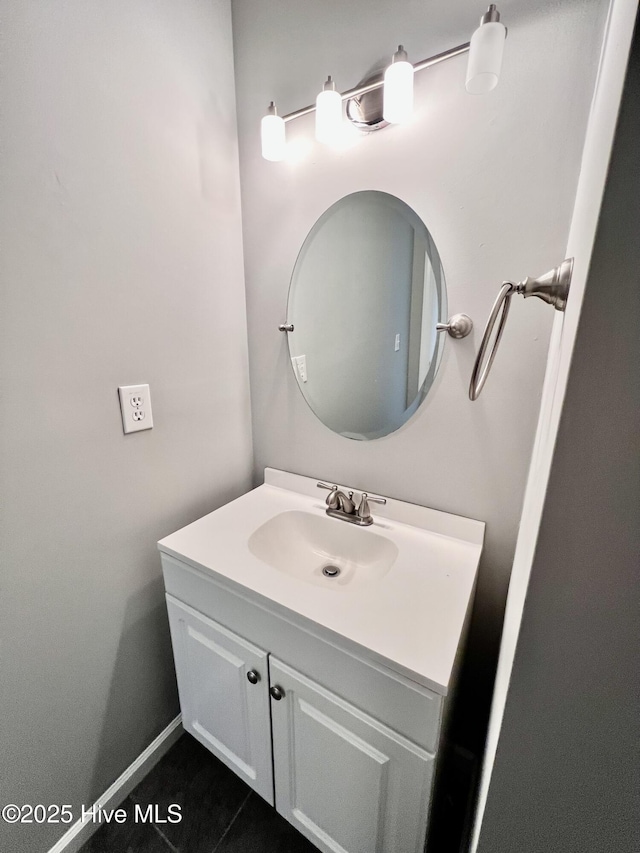 bathroom featuring tile patterned flooring, vanity, and baseboards